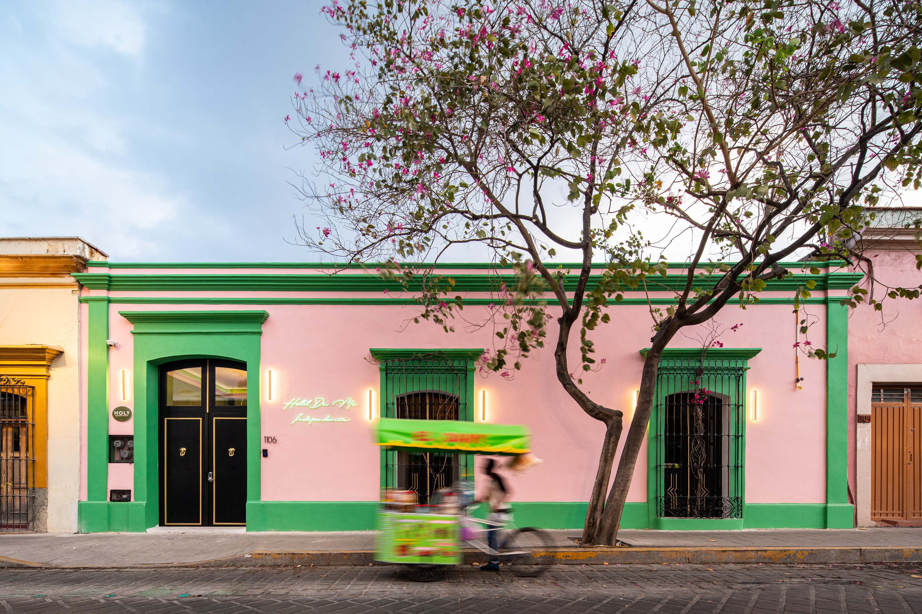 Hotel De Mi Independencia, a pink and green colonial facade in Oaxaca